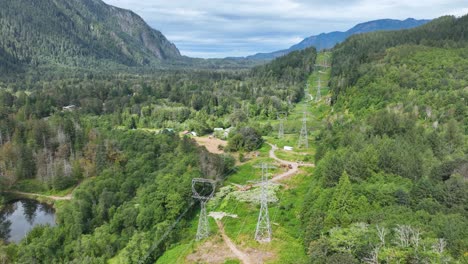 aerial view of electrical cables passing through the forest-filled cascade mountains