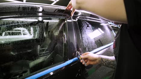 man covering car with vinyl polyurethane tape. films for the car. sticker protective film on the car