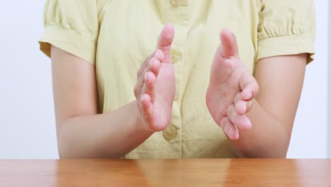 a close-up shot captures the joyful clapping of hands symbolizing happiness and celebration in a bright indoor setting