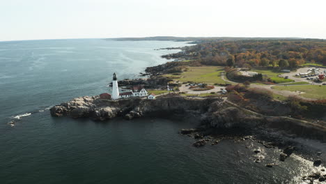 scenic aerial shot of portland head light, maine, calm waters