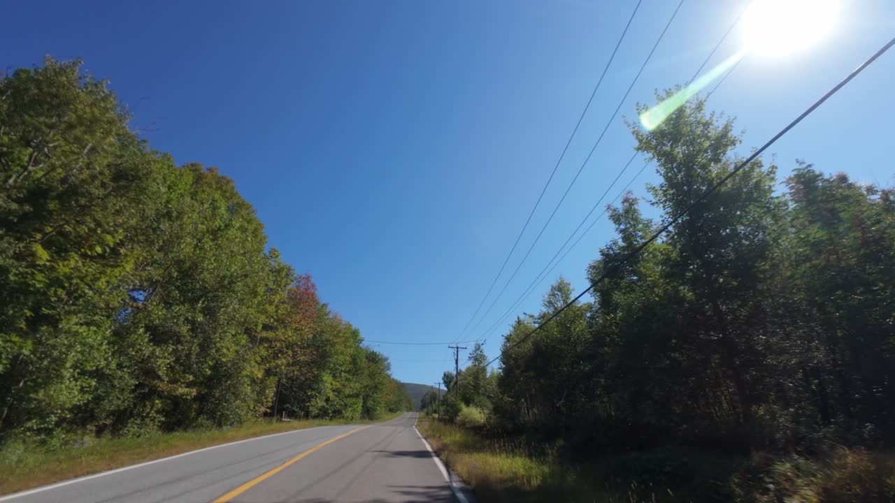 Highway Through Forest Trees During Summer Near Mont Sutton In Quebec, Canada. POV Shot