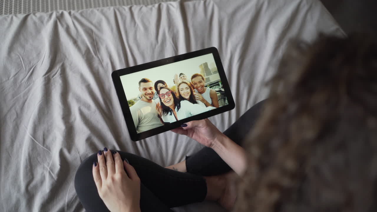 Woman Viewing Friends' Selfie on Tablet