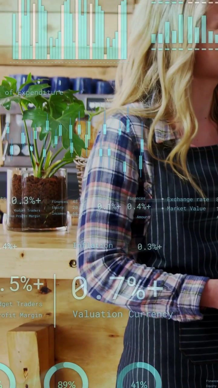 Vertical video: Shop worker tapping tablet, charts overlaying torso, cafe shelves, monitoring sales