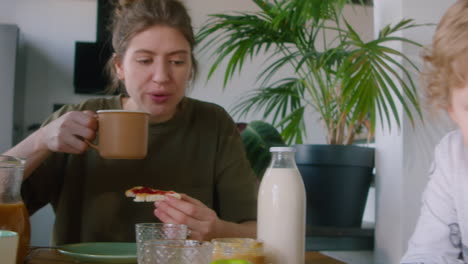 lesbian parents having breakfast with son at home