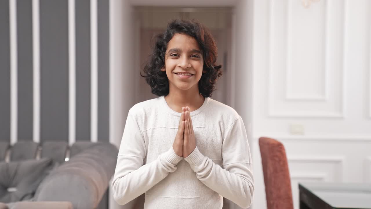 Polite Indian boy kid doing Namaste and greetings
