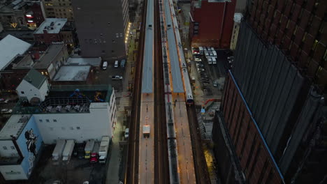 aerial view tilting over the 125th street railway station, gloomy evening in harlem, ny, usa