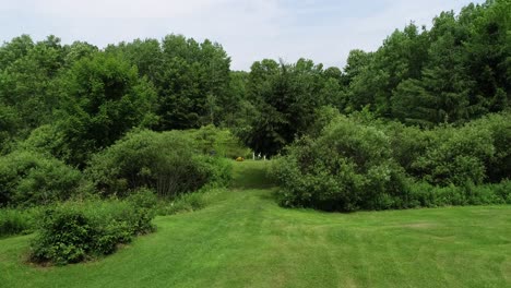 a drone rises over a well kept property to reveal a small private bass pond