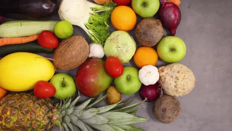 fresh organic and ripe healthy fruits and vegetables filling the kitchen table. stop motion