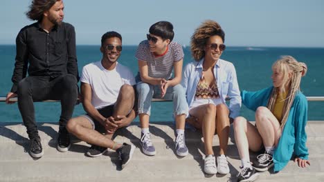 stylish young friends on city embankment