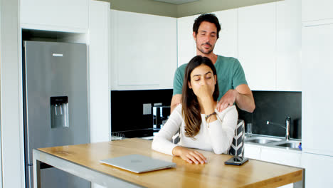 Man-massaging-woman-shoulders-in-kitchen-4k