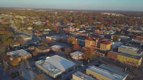 Early-morning-aerial-view-over-small-town-down-town-with-flight-toward-small-church