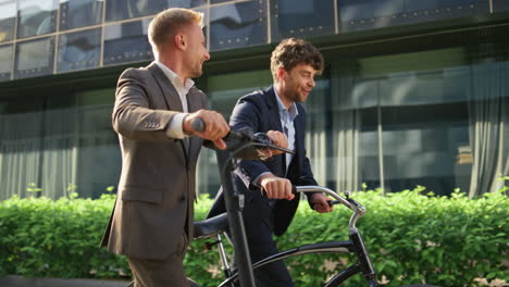 businessmen legs commute street in morning closeup. two guys holding bicycle