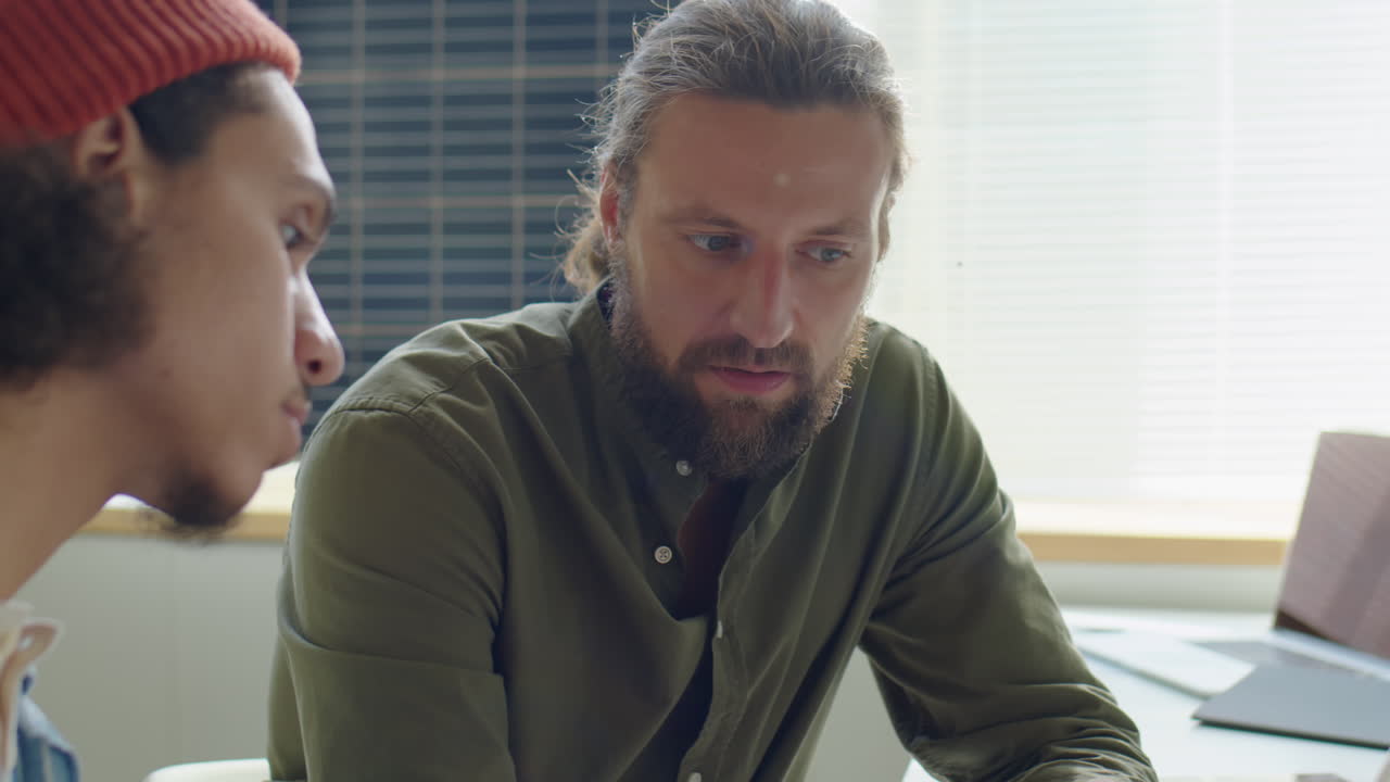 Engineer Discussing Wind Energy Project with Coworker