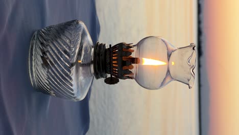 Vintage-table-oil-lamp-against-the-backdrop-of-the-sunset