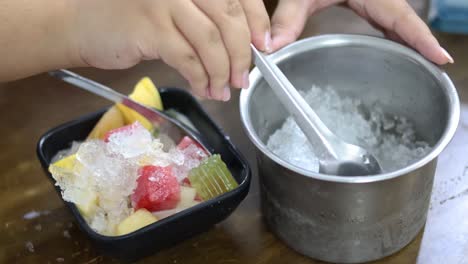 adding ice to a fruit dessert