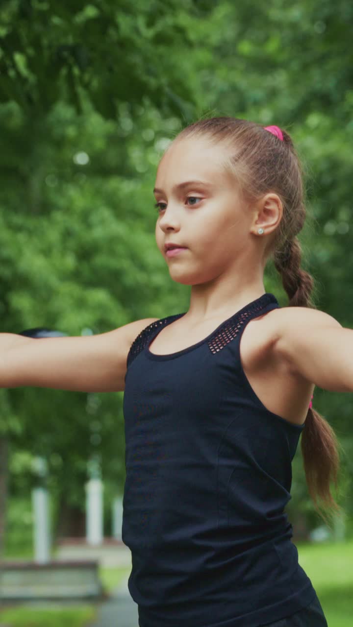A Young Girl With Confidence Perfects Her Focus and Balance in a Serene Outdoor Setting Surrounded by Lush Greenery and Natural Beauty