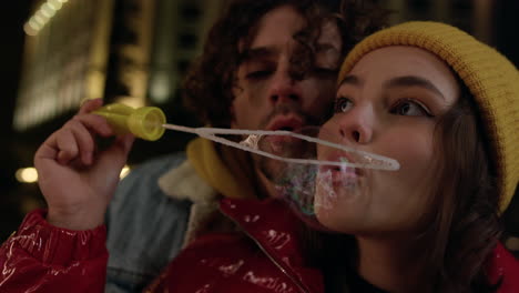 Romantic-couple-blowing-soap-bubbles-in-city-center.-Man-and-woman-having-date.