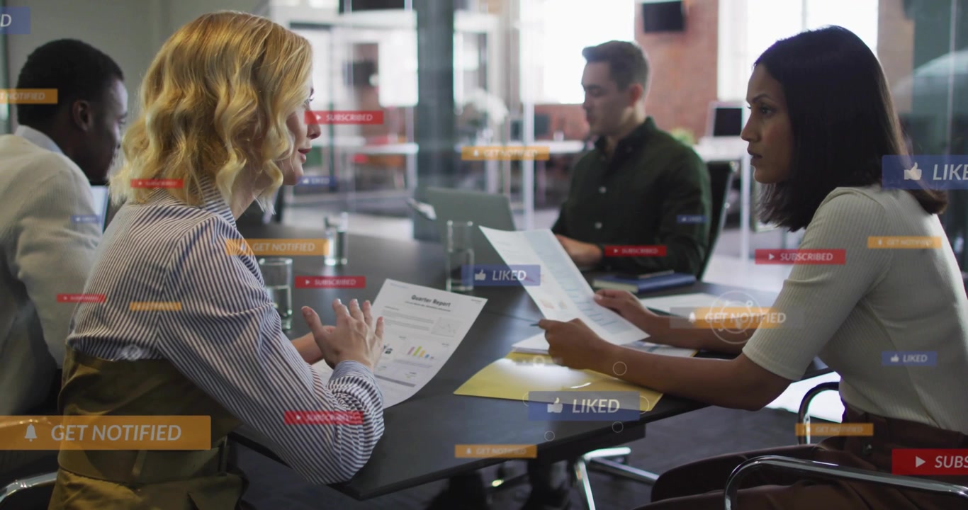 Women reviewing docs in business meeting, discussing charts, sparking badges rising above table