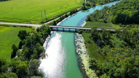 average simple small concrete bridge, road over river in rural countryside area