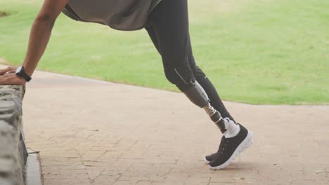 side view man with prosthetic leg stretching