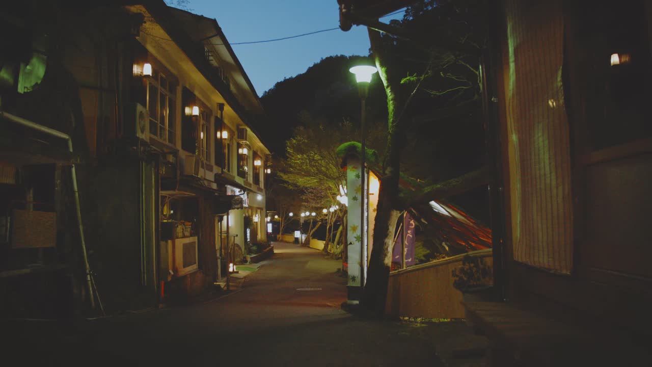Empty And Quiet Street At Night Along The Buildings In Japan. - wide shot