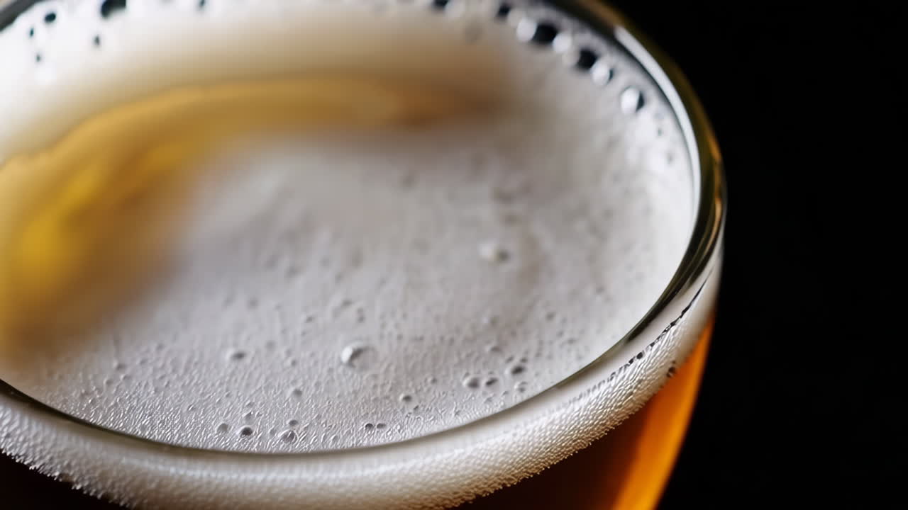 Close-up of a glass of beer with foam