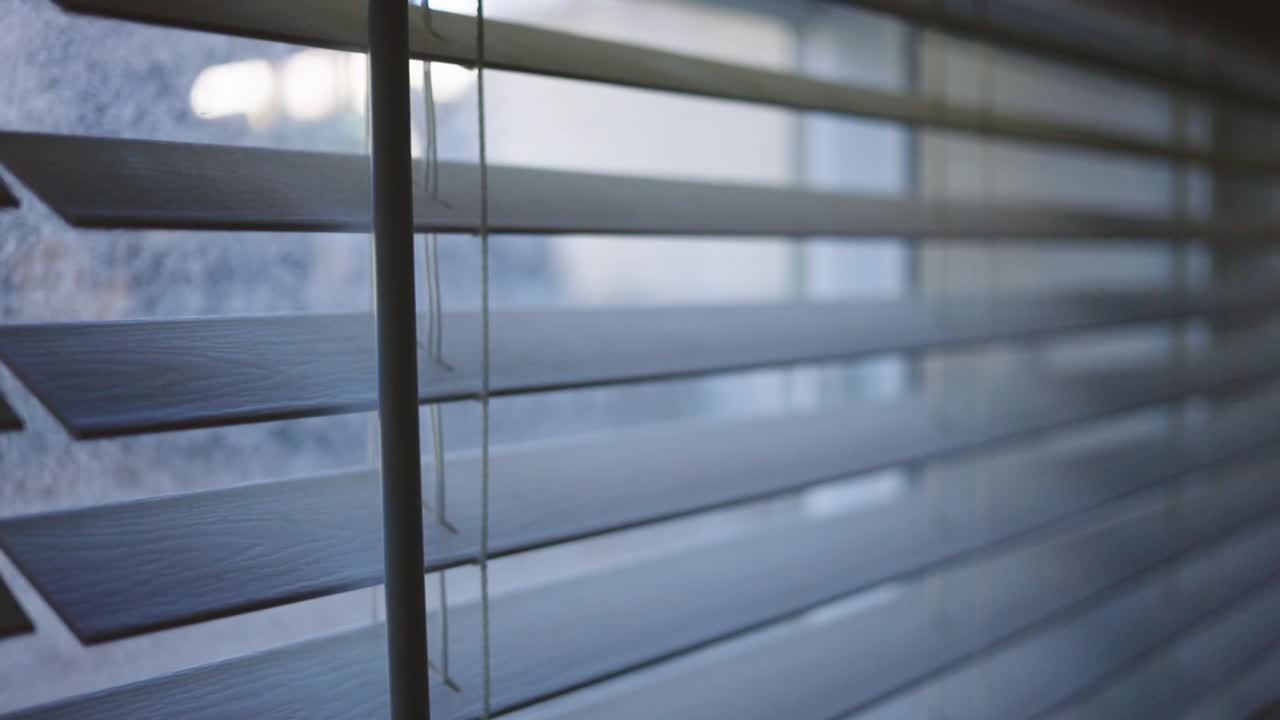 White Wooden Shutters On The Windows In The Living Room Of A House. Windows Blinds. - pan down