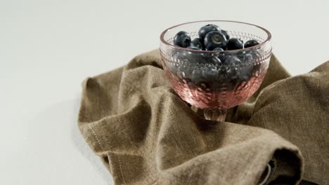 Blueberries-in-glass-bowl-placed-on-napkin-4K-4k