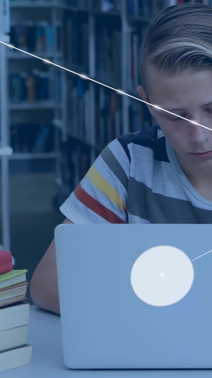 Vertical video: Student using laptop in library line sweep starting WiFi cell icons forming edu web