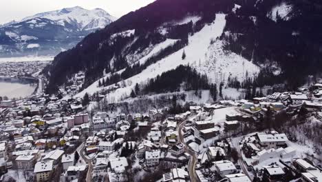 aerial view of zell am see village, austria winter scenery, dolly in, day