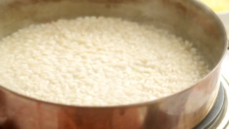 unrecognizable cook preparing risotto in pan