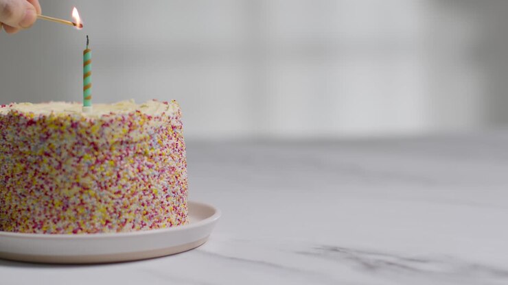 Studio Shot Birthday Cake Covered With Decorations And Single Candle Being Lit 1