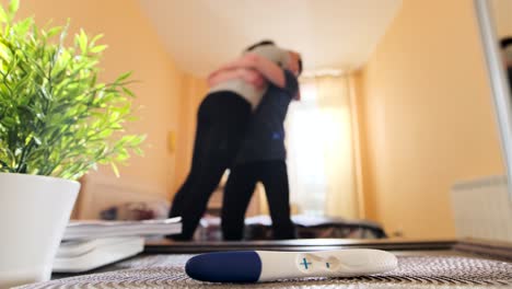 excited couple reacts to a positive pregnancy test