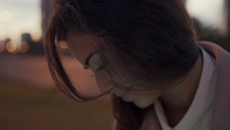 serious concentrated young beautiful woman entrepreneur using an ipad tablet and phone, close up slow motion