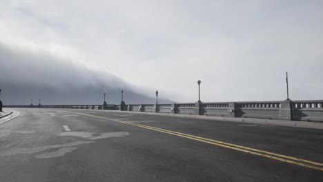 Asphalt-highway-and-mountain-in-deep-fog