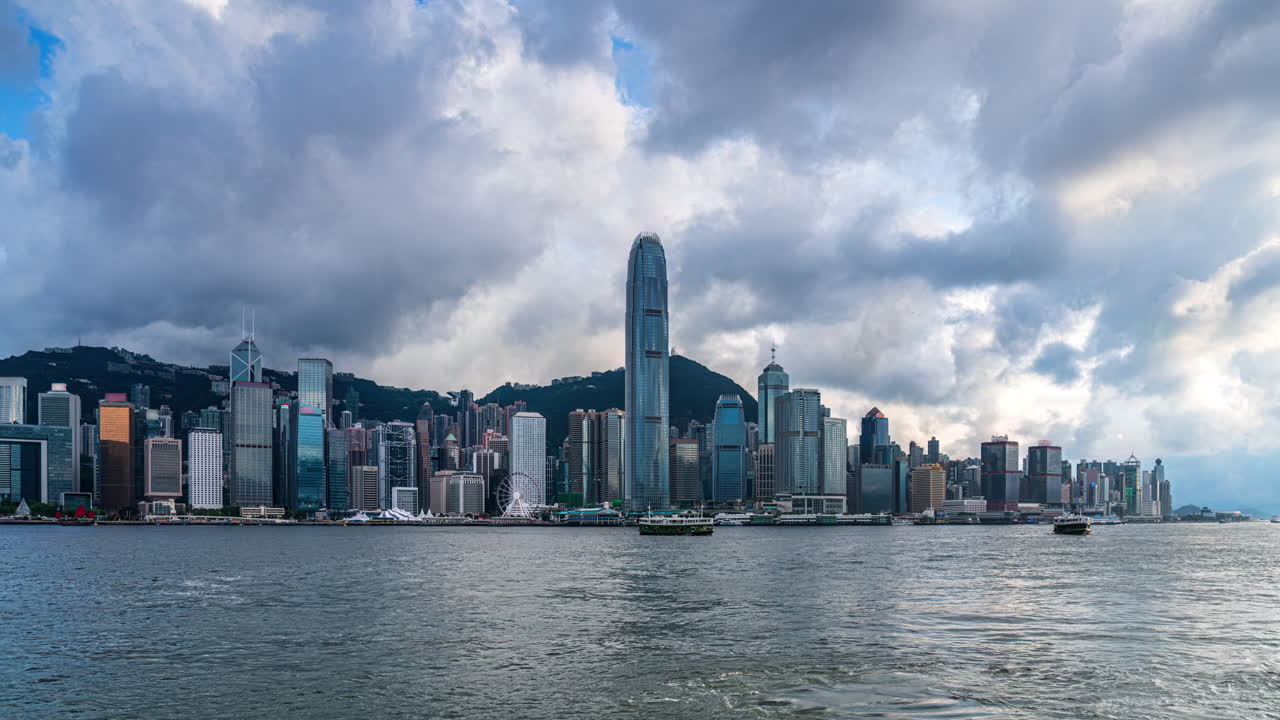 Time lapse of clouds moving over Victoria Harbour Hong Kong skyline in spring afternoon