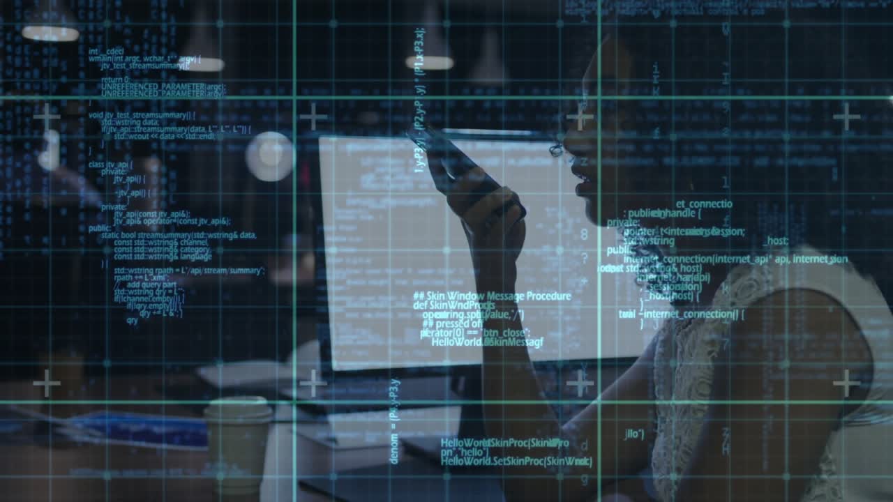 Woman raising phone, typing, scrolling at tech desk while code grid moving on monitor for debugging