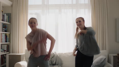 happy-teenage-girls-dancing-at-home-best-friends-having-fun-enjoying-funky-dance-moves-celebrating-vacation-weekend-at-home-wearing-pajamas