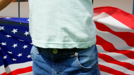 mid section of caucasian schoolboy holding american flag in school 4k