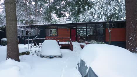 cottage with vehicles thickly covered with fresh snow in countryside of tacoma, washington state, usa