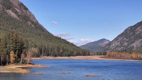 dunn lake's symphony: evergreen mountains and fall foliage unite