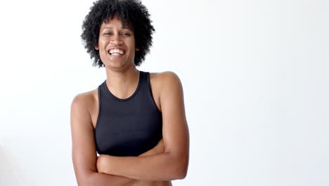 Biracial-woman-laughing,-wearing-black-sportswear