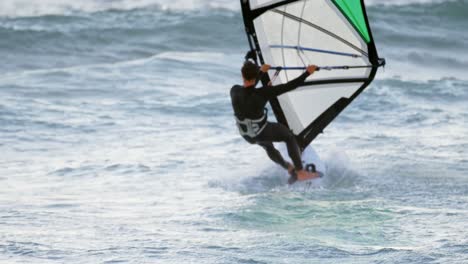 male surfer windsurfing in the beach 4k