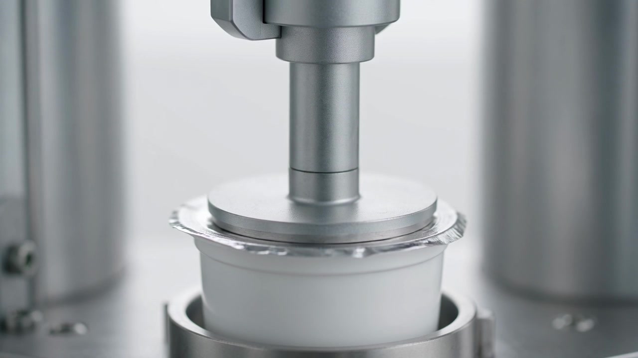 Industrial Machine Sealing Foil Lid on Plastic Yogurt Cup