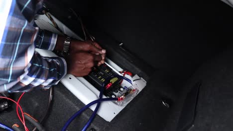 removing the plastic from copper wire, doing an installation in a car or vehicle boot.