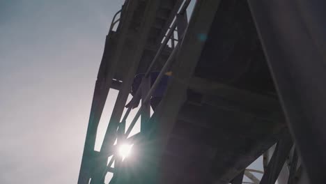 Construction-worker-walking-up-stairs-on-a-modern-industrial-site