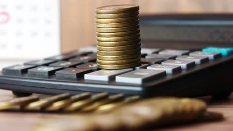 stack of coins on a calculator