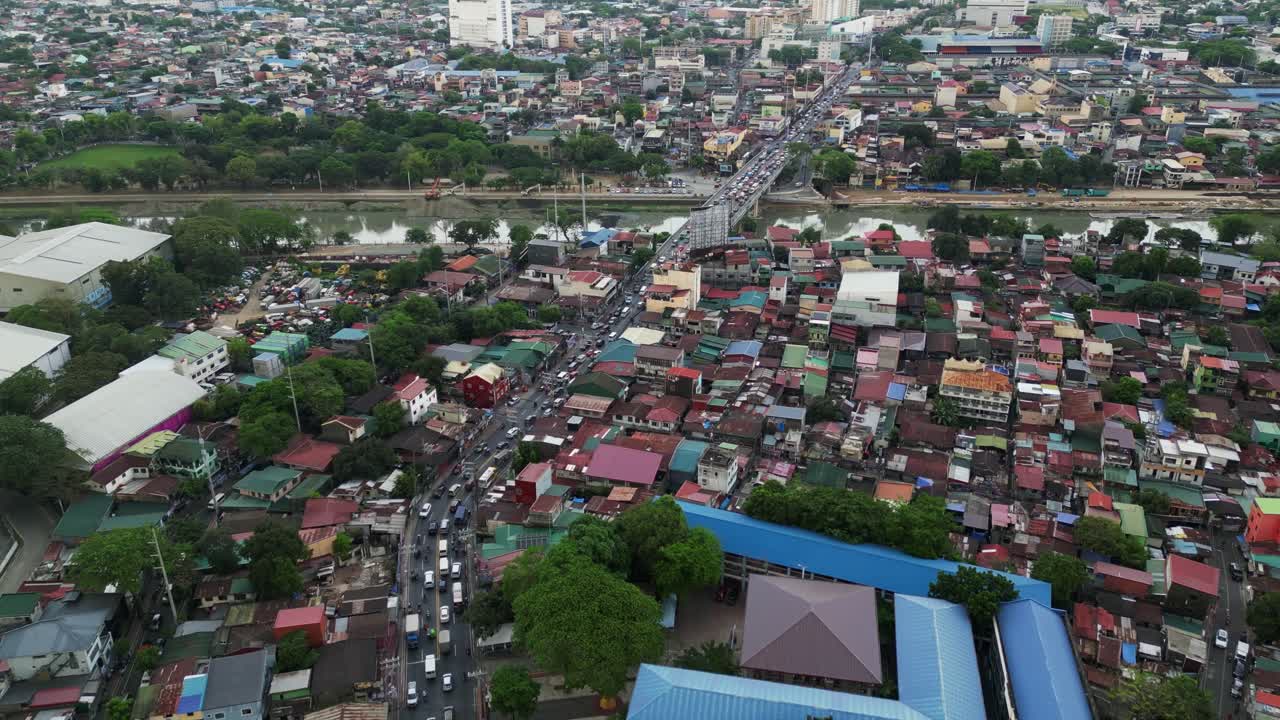 Dense Marikina neighborhood from above with houses, rooftops, and narrow connecting streets, high angle aerial overview of rush hour traffic
