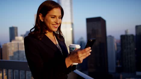 una mujer de negocios latinoamericana usando una aplicación en el techo de sunrise