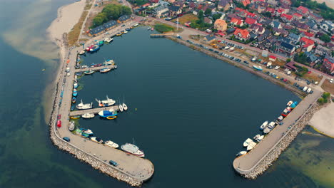 aerial view of small marina in kuznica, poland with moored yachts and fishing boats